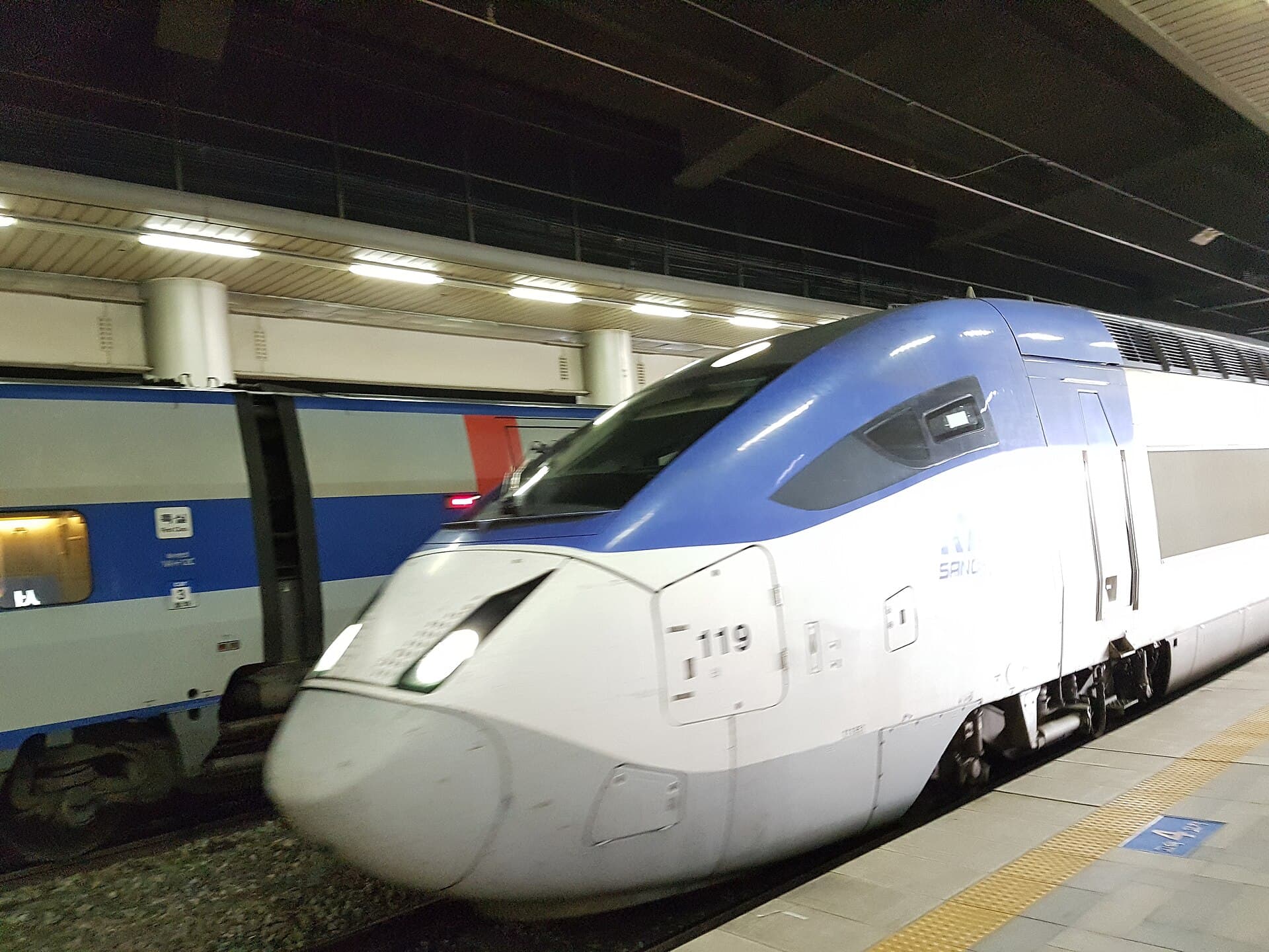 A KTX high-speed train waiting at a platform